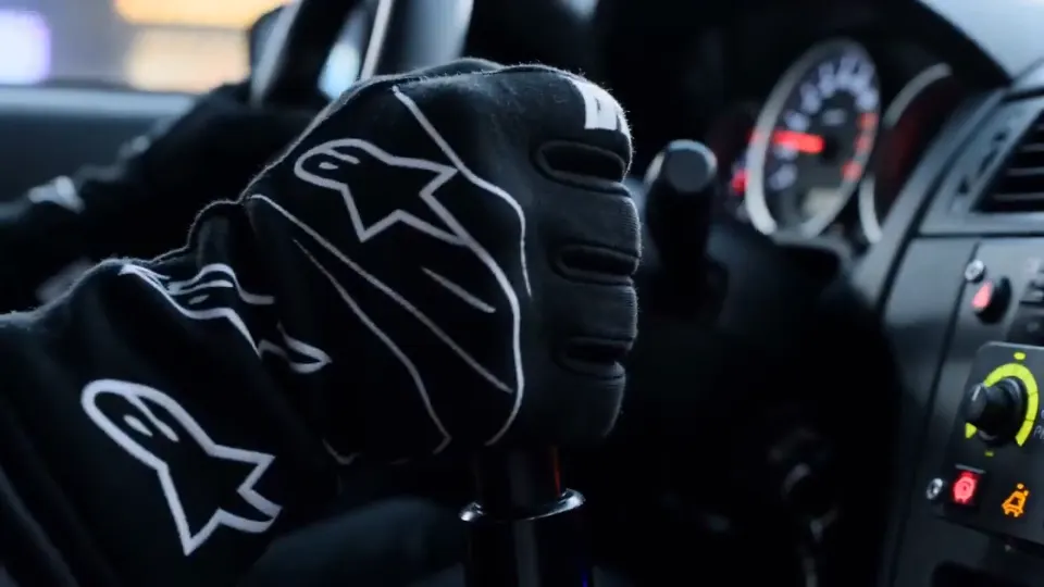 cinematic street racing sequence at night, a focused driver inside a high-perfor